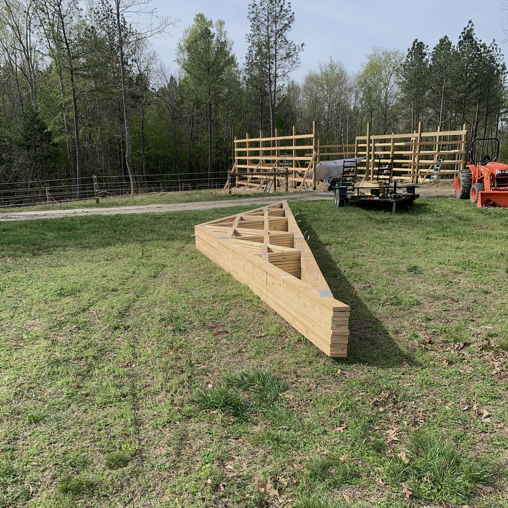 A completed wood truss staged and ready for delivery